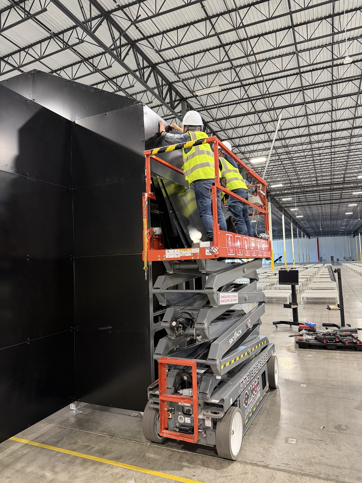 Technicians using a scissor lift during an industrial installation